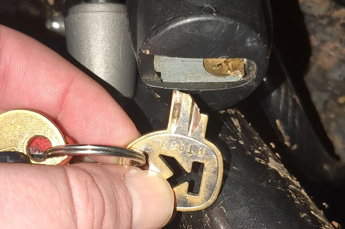 Broken key held up in front of lock